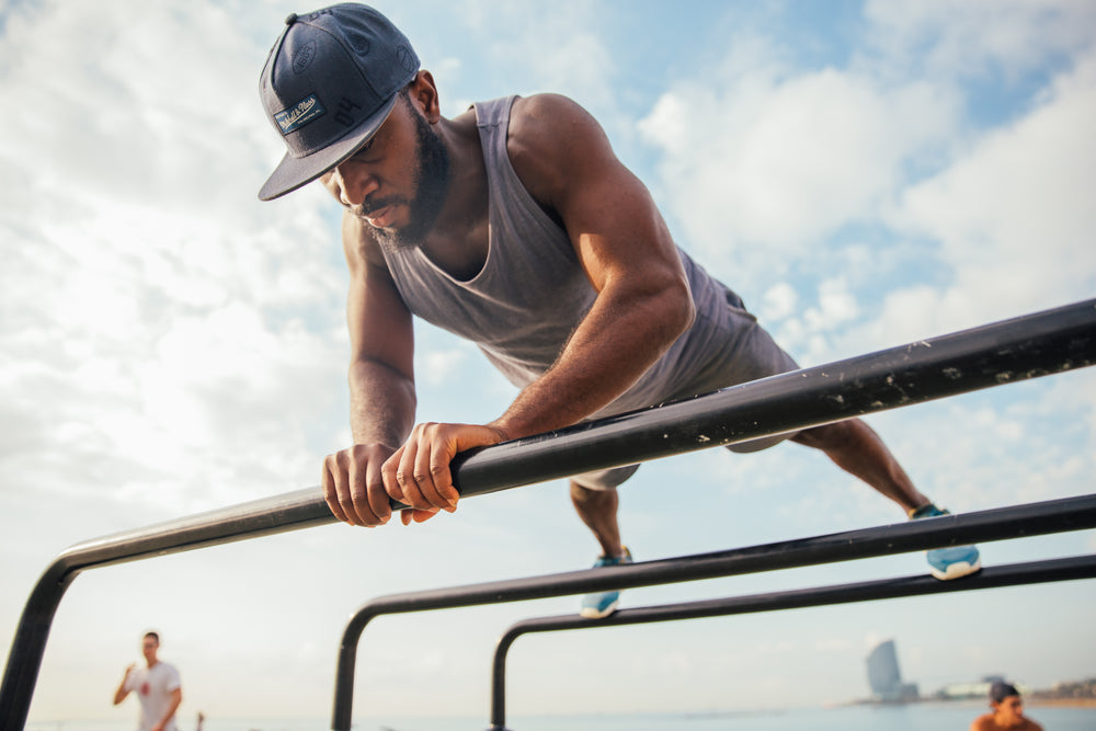 man doing pushups on bars