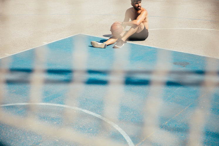 Man Sitting On Basketball Court