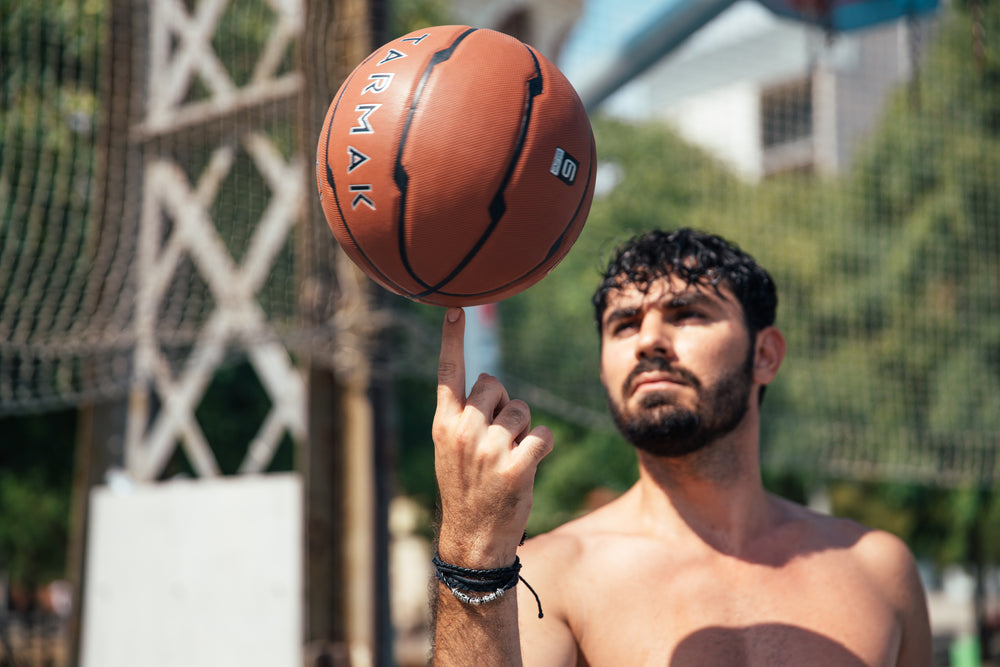 man spinning basketball on finger