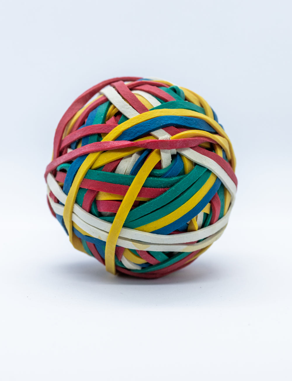 a ball of rubber bands on white