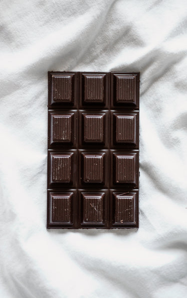 a bar of dark chocolate on white