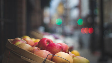 a basket of apples in an outdoor market