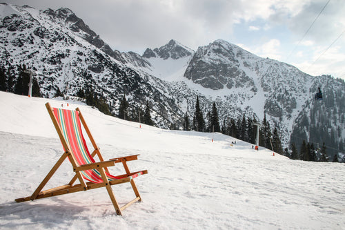 a beach chair on snow covered mountain