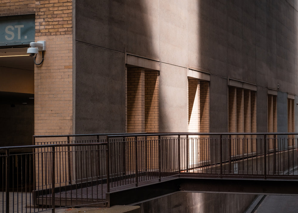 a beam of light strikes the side of a city building