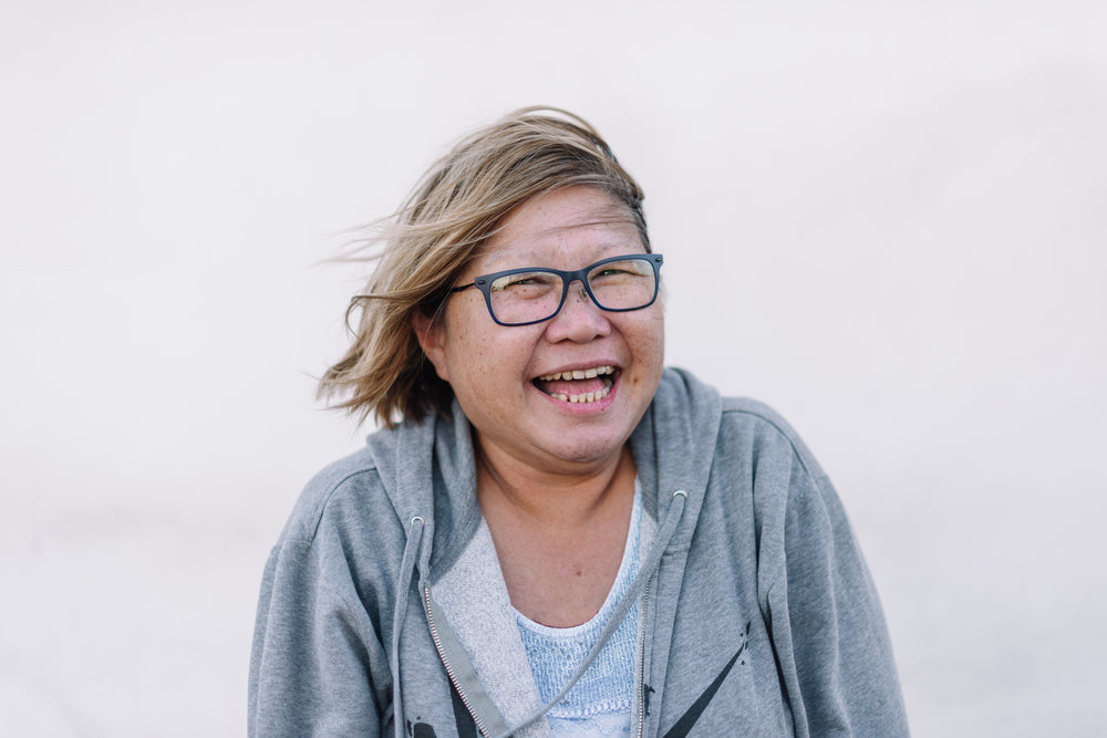 a beaming windswept woman of asian background