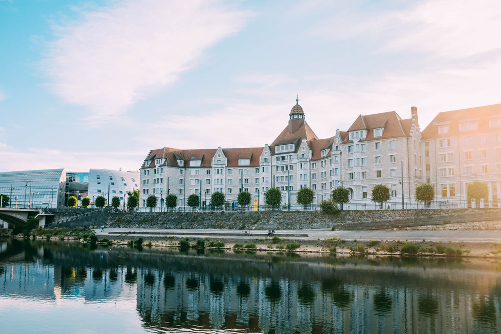 a beautiful building reflected in a river