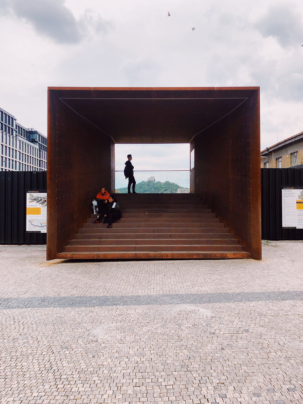 a big square steel walkway with steps