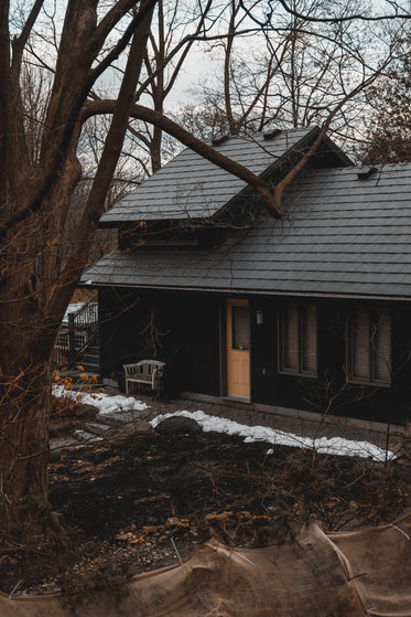 a black cabin with a yellow door