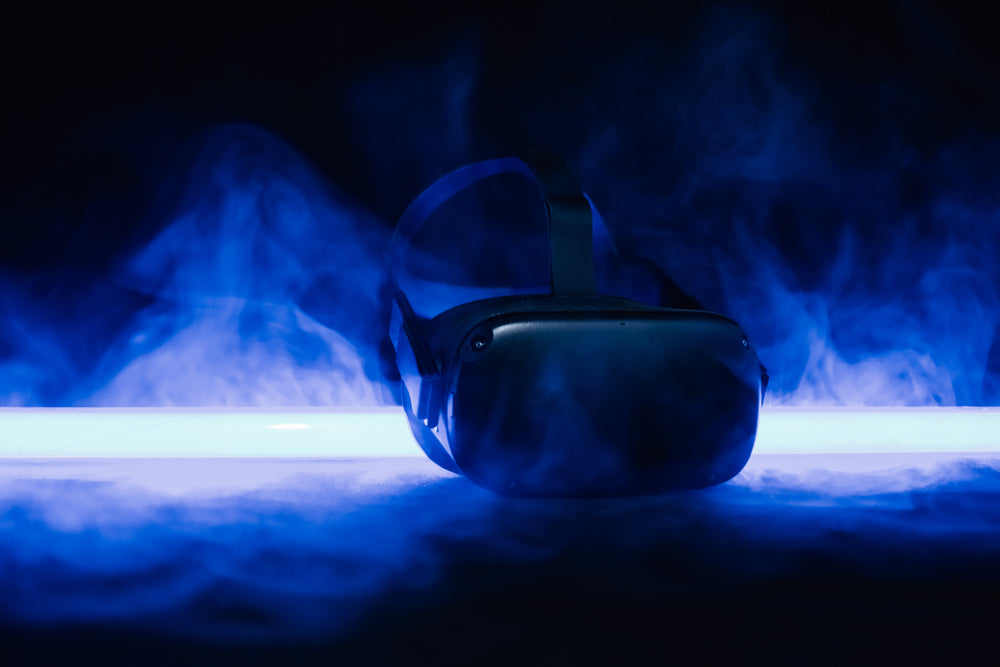 a black headset surrounded by fog in blue light