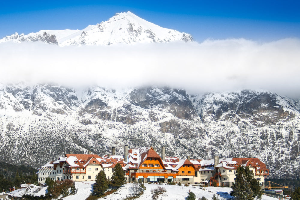 a blanket of mist over a large ski resort on a mountain