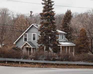 a blue home with snow covering the roof