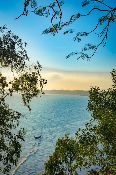 a boat in aqua blue water at sunrise