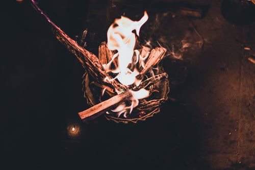 a bowl of kindling set aflame