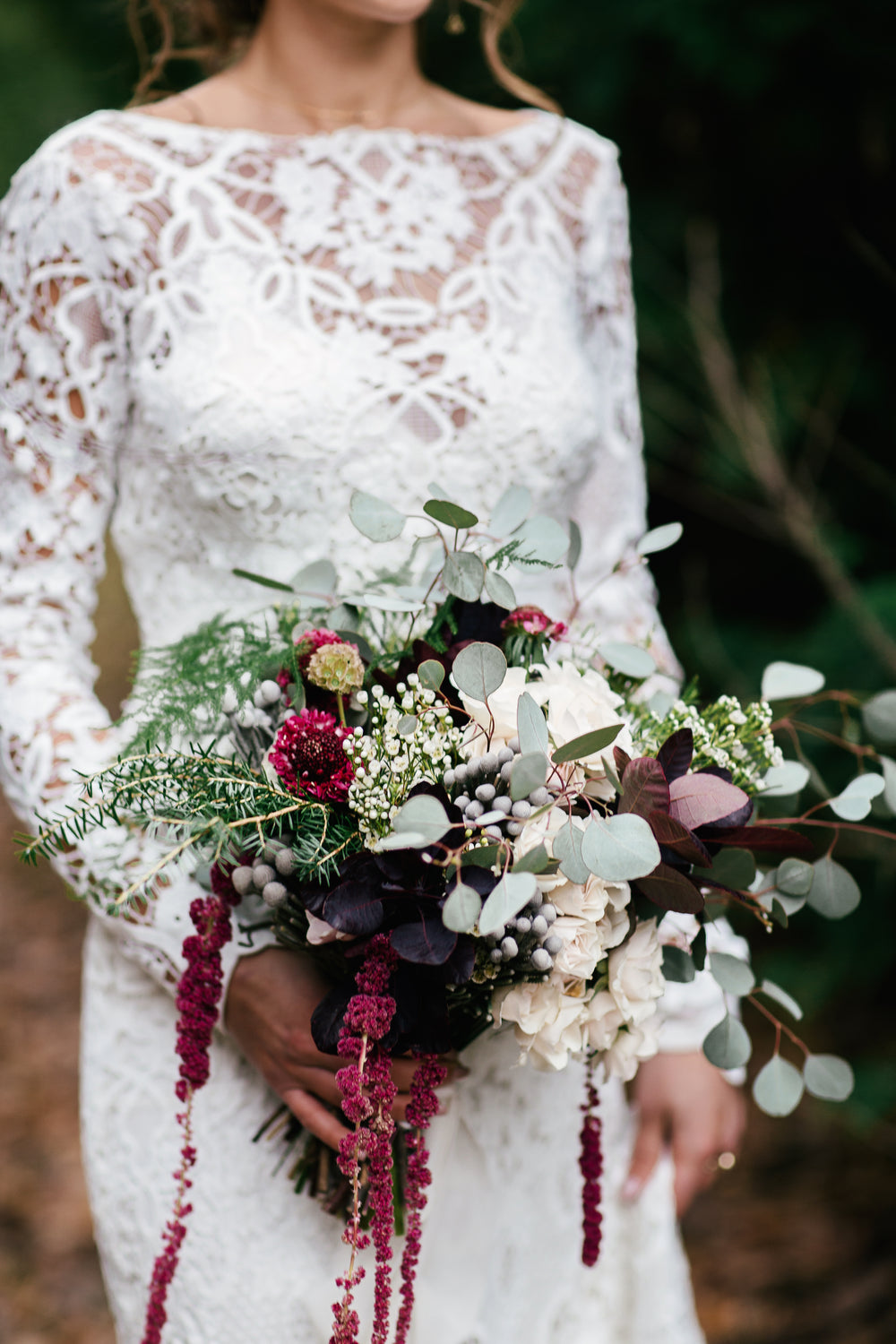 a bride holds her bouquet while walking down the isle