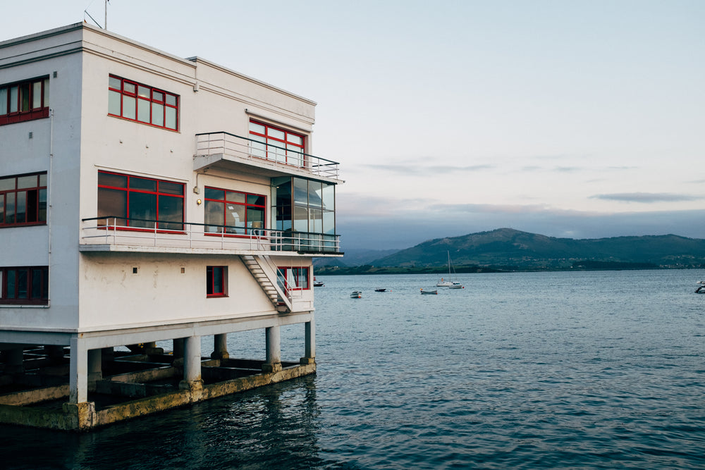 a building on pillars in the waters of a bay