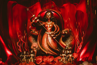 a carved figurine on a red background