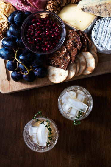 a cheese board accompanied by drinks