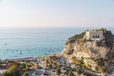 a church sits atop colorful beach