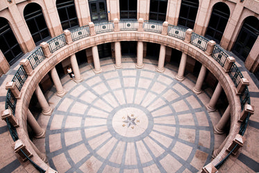 a circular tiled courtyard with overlooking archways