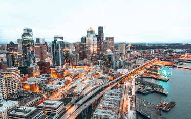 a city skyline illuminated as the sun starts to set