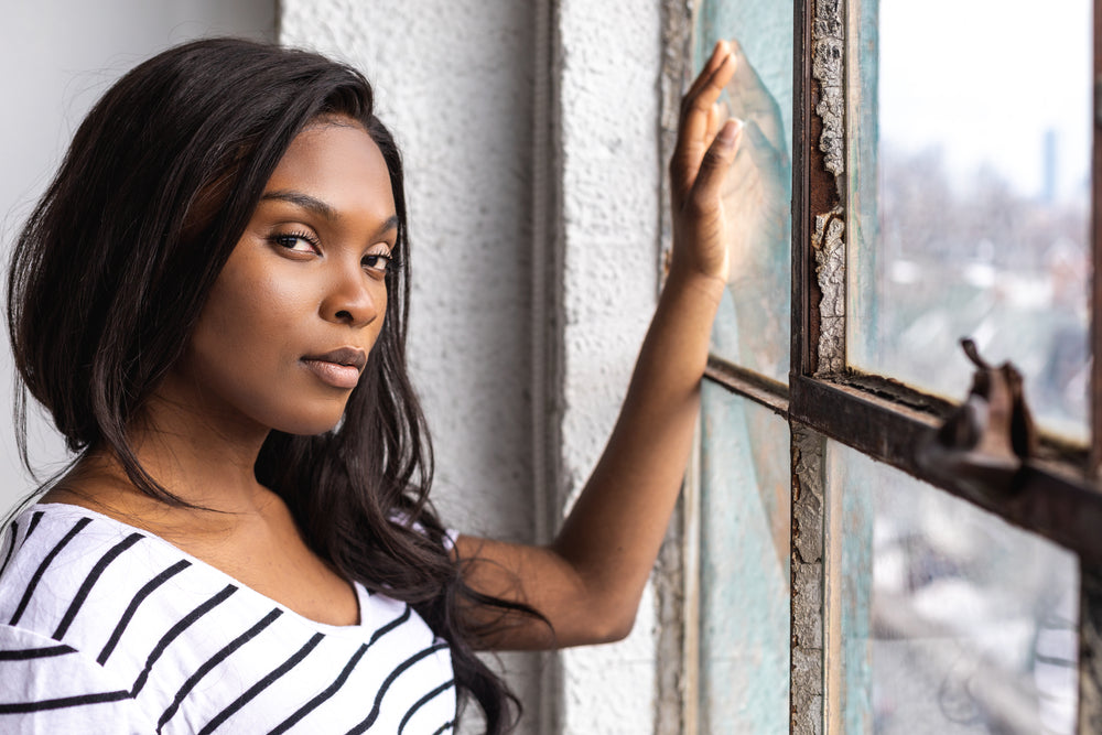 a close up of a woman leaning into a window