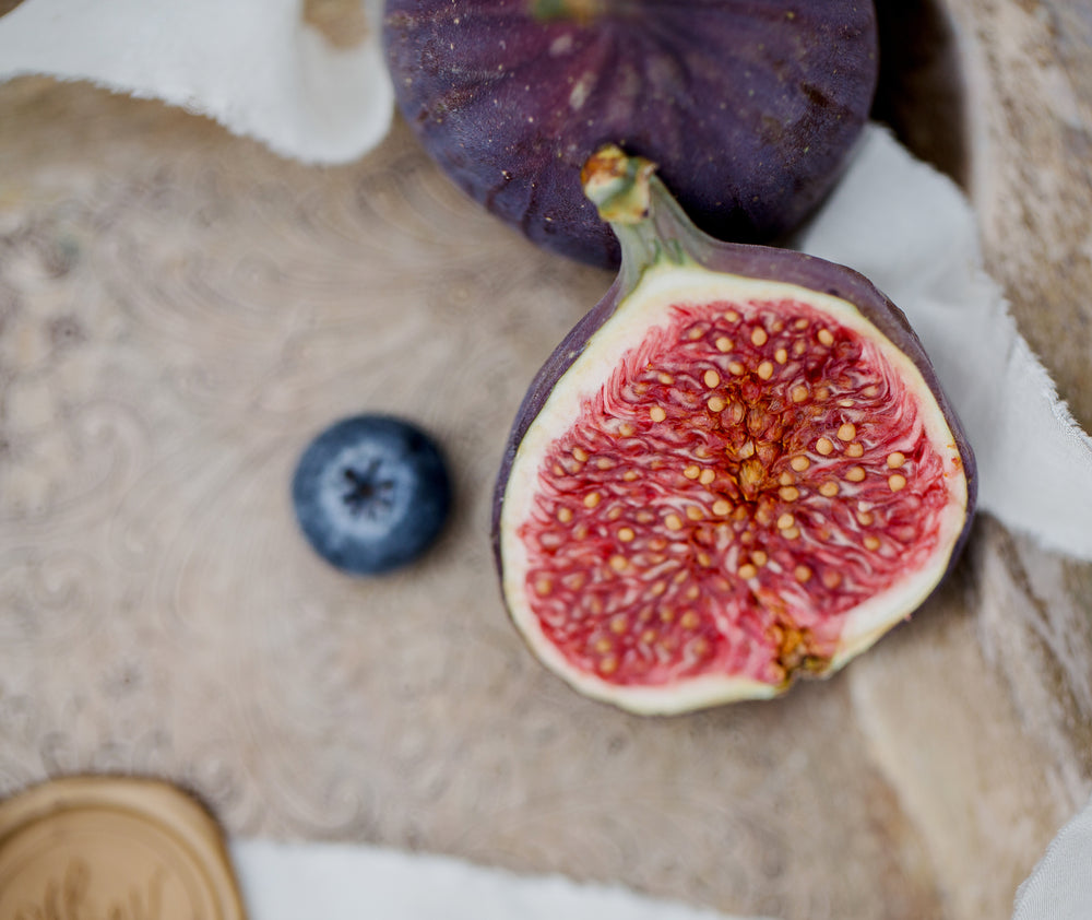 a close up of half of a fig