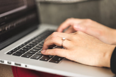 a close up of hands typing on a keyboard