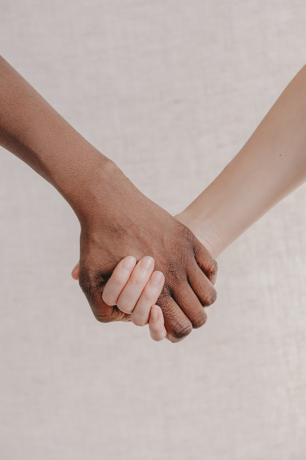 a close up two people holding hands together