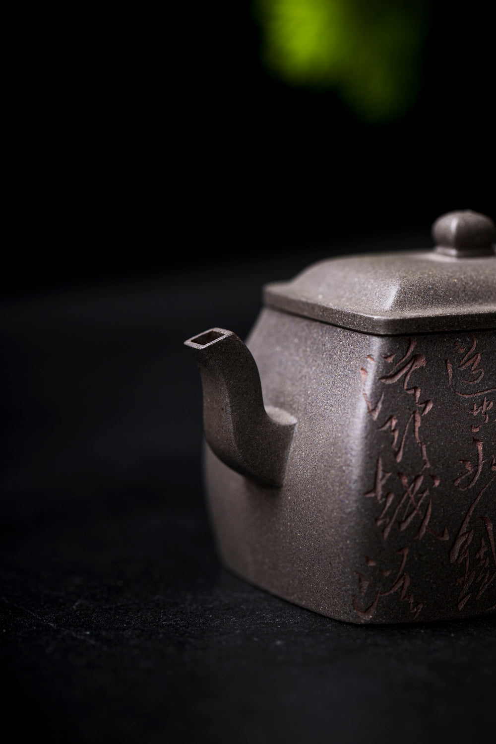 a close up view of a grey teapot with a square spout