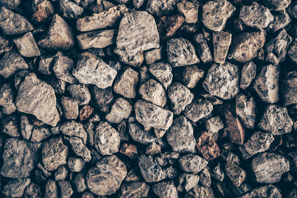 a closeup view of large jagged mountain rocks cover the ground