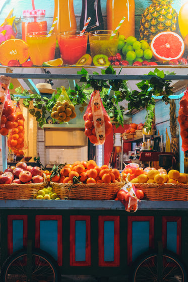 a colorful fruit cart on wheels