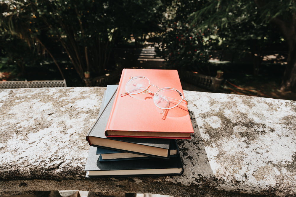 a colorful stack of books and glasses