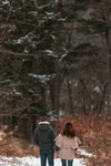 a couple enjoying a brisk walk through the woods