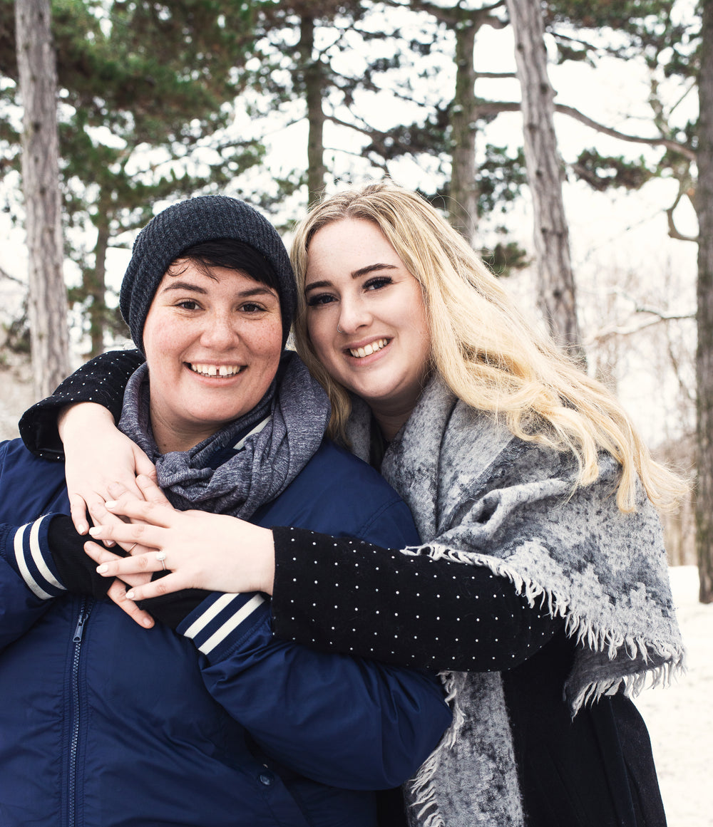 a couple hold each other and share a smile