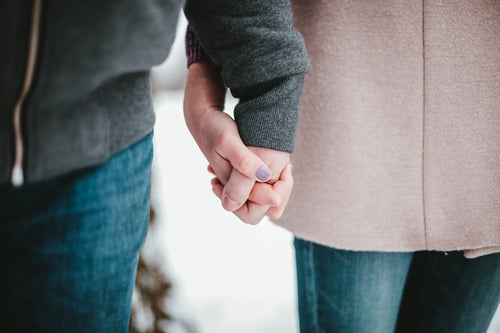 a couple holding hands in winter