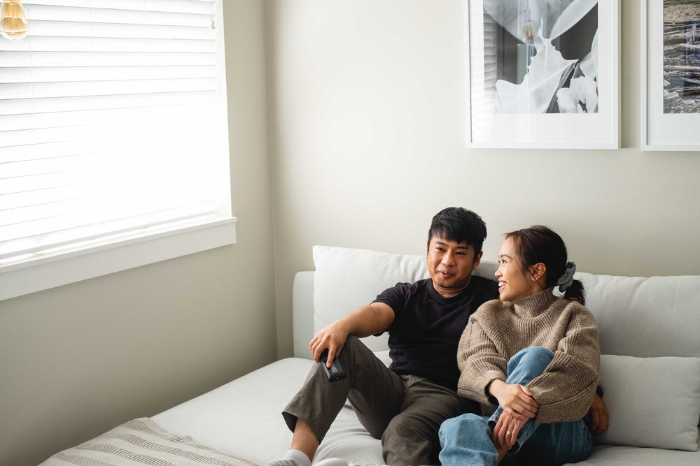 a couple relax on a white couch in their living room