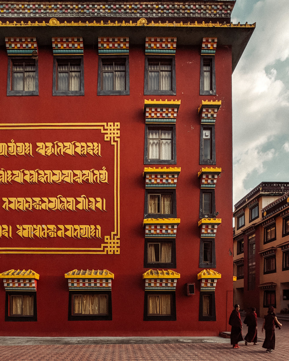 a crimson building with gold writing on the walls