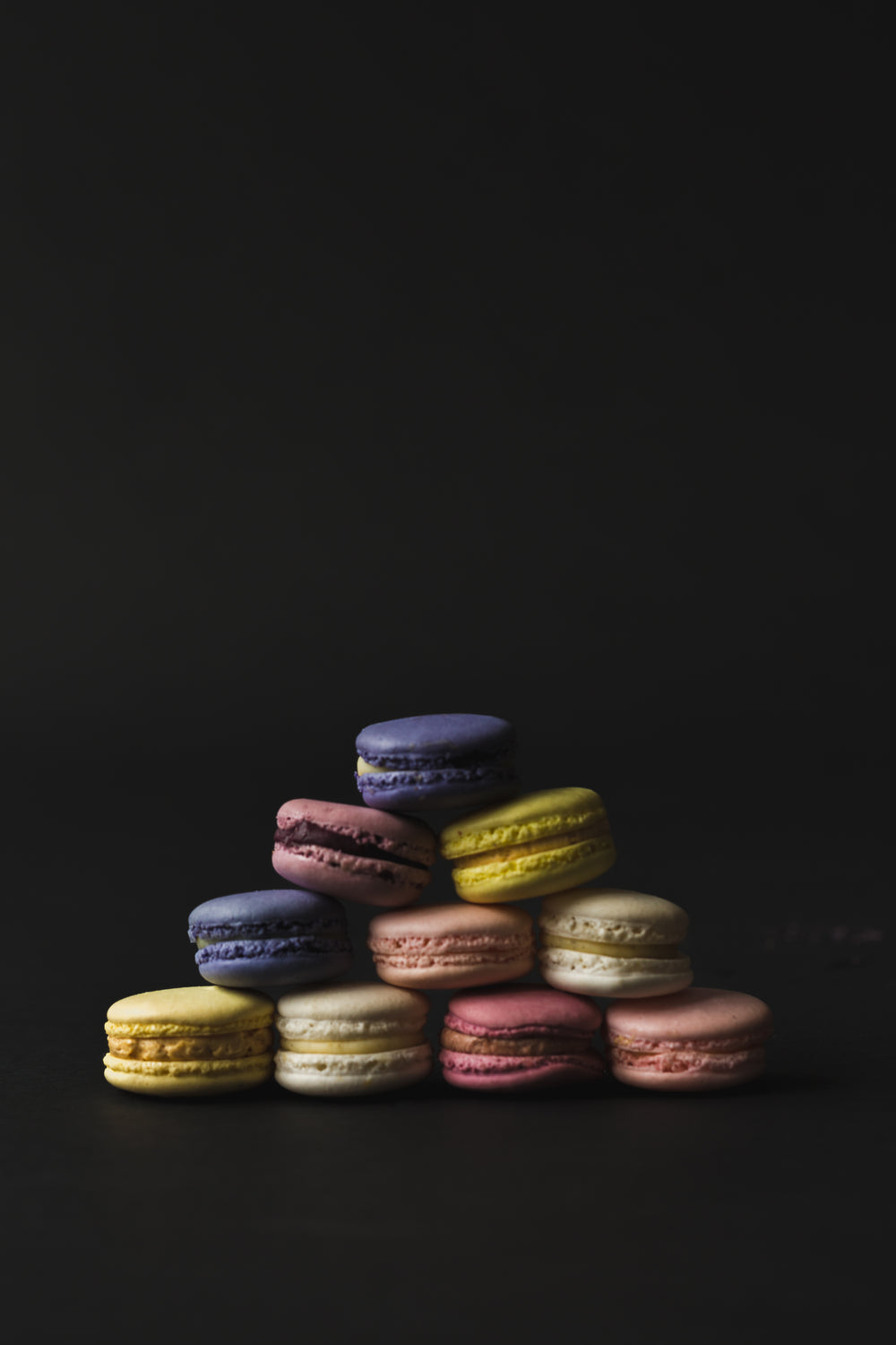 a dark and moody macaron pyramid