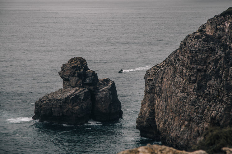 a-dinghy-cuts-through-the-grey-sea.jpg?w