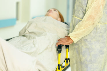 a doctor visits a woman in a hospital bed