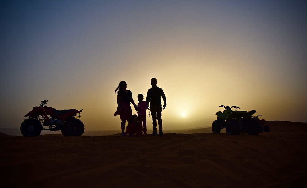 a family on a sunset quad-bike adventure