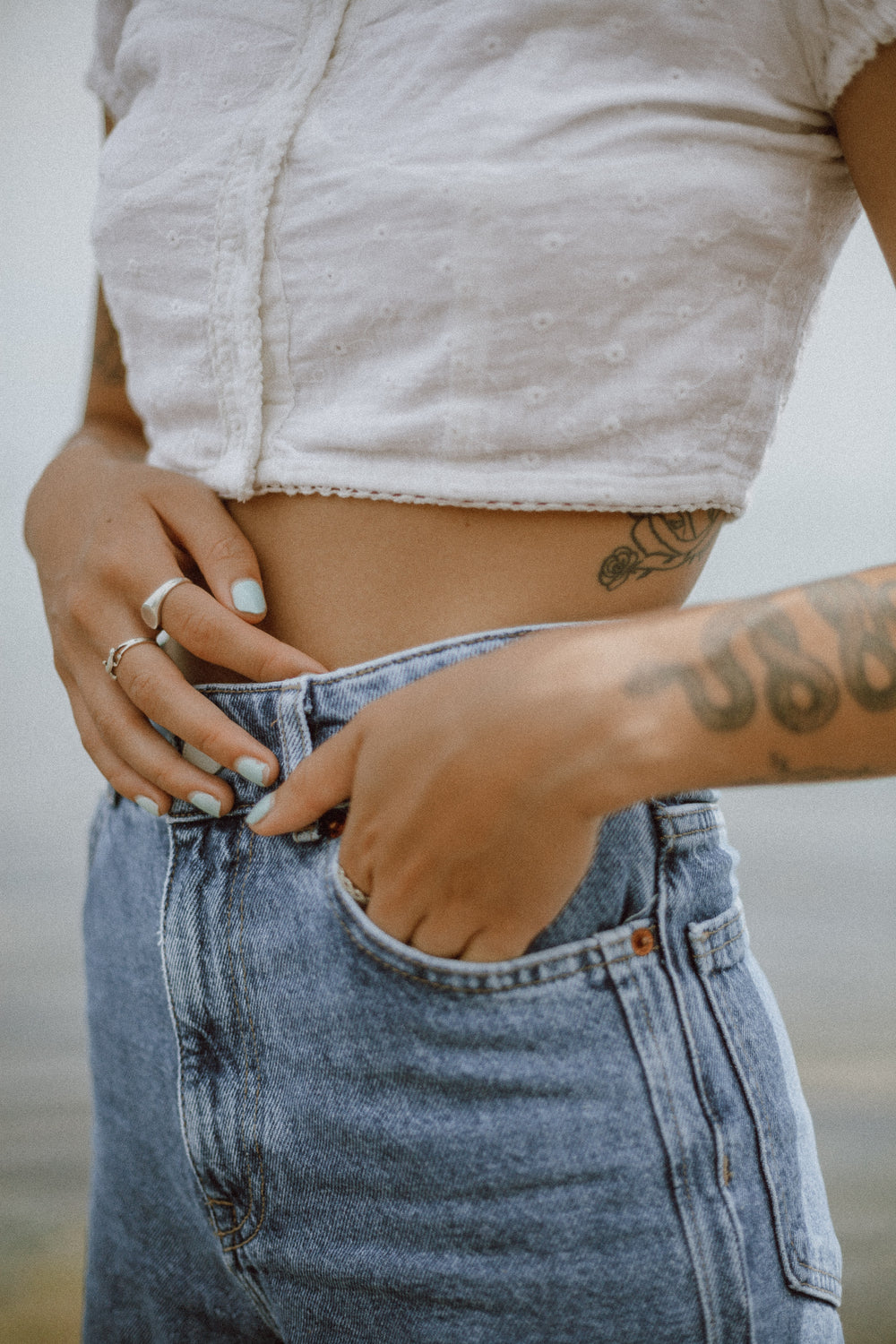 a fashionable person with tattoos poses