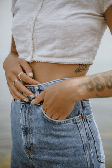 a fashionable person with tattoos poses