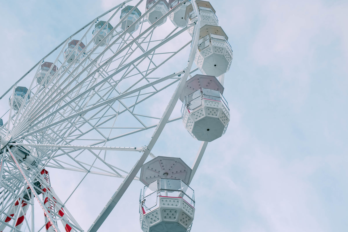 a ferris wheel against a moody blue sky