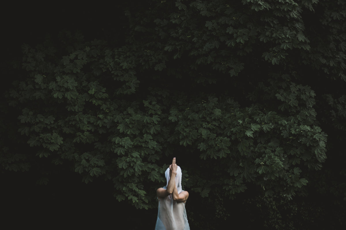 一个裹着白纱布的人在树林里摆姿势