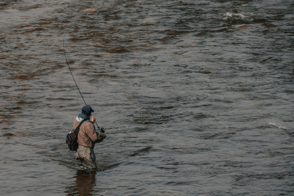 a fisherman reels in