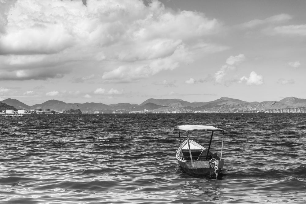 a fishing boat bobs off the city coastline