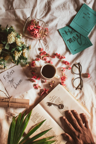 A Flatlay Of Plants Coffee And Open Notebook