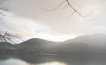 a foggy sunrise reflects off a chilly lake