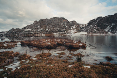 a frozen winter landscape below mountain